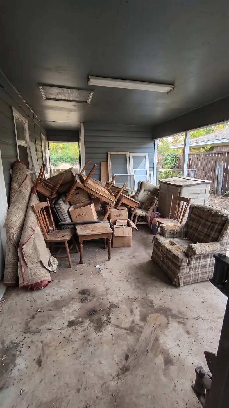 Furniture and unwanted items before a covered driveway cleanout in Denton